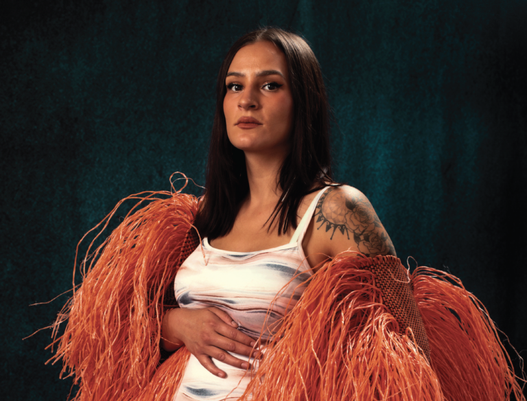 Leah Rose, Indian Market artist, poses while pregnant and looking at the camera